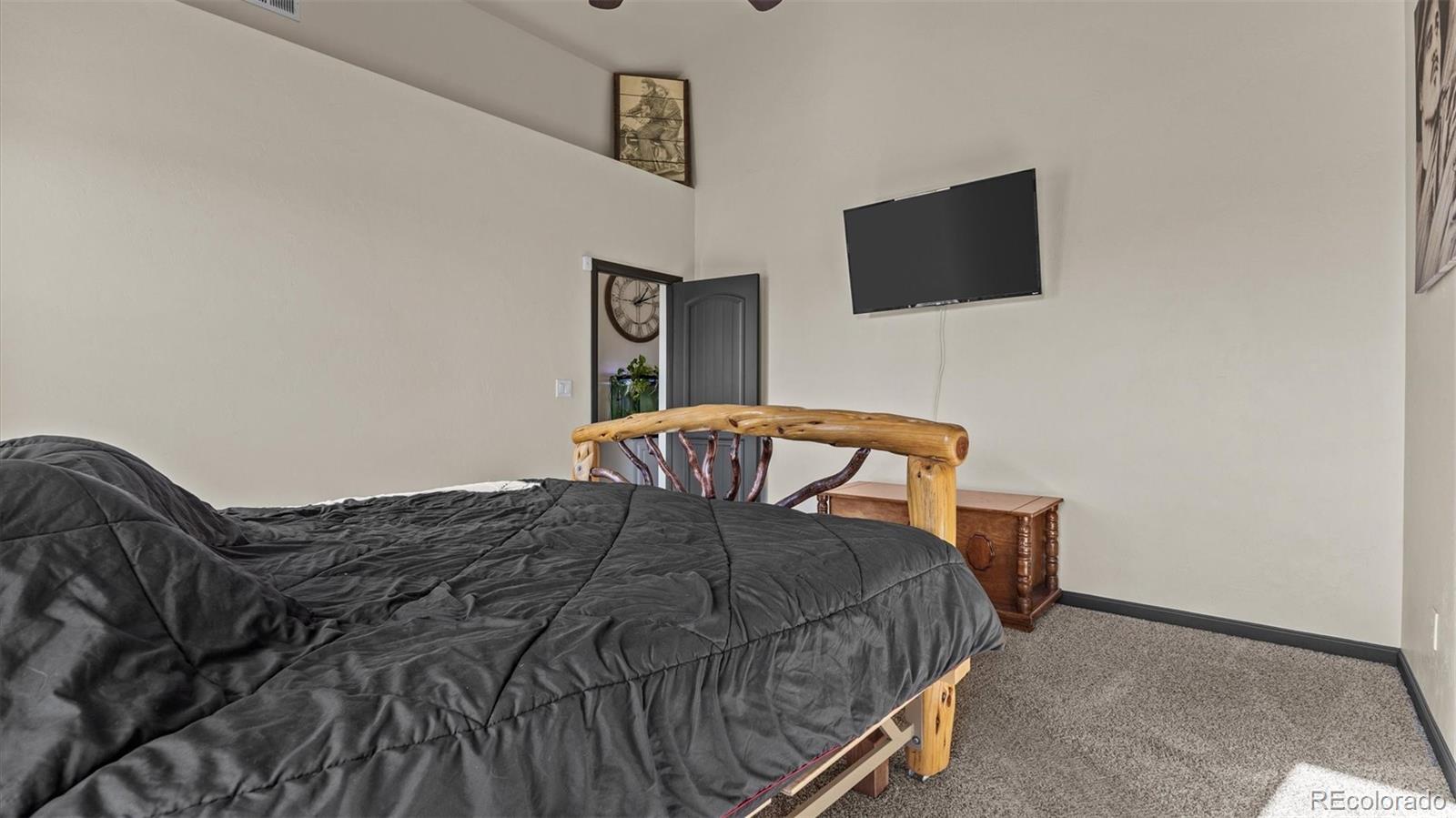 556-32 32 5/8 Road Clifton, CO 81520 - Photo 17 of 28 a bedroom with a bed and a flat screen tv