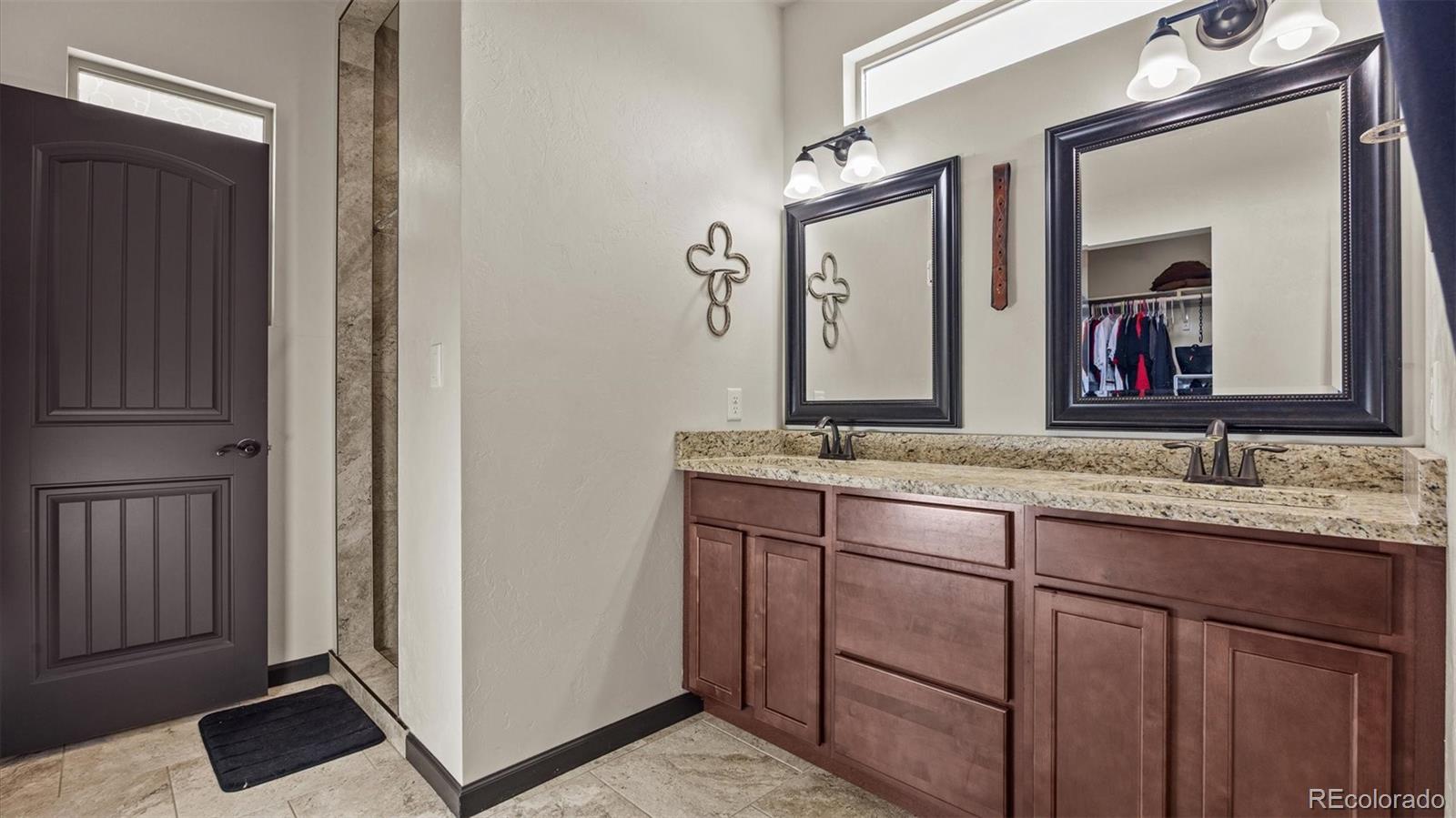 556-32 32 5/8 Road Clifton, CO 81520 - Photo 19 of 28 a bathroom with a granite countertop double vanity sink and a mirror