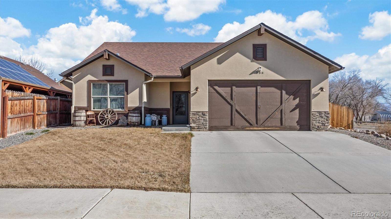 556-32 32 5/8 Road Clifton, CO 81520 - Photo 2 of 28 a front view of a house with a yard and garage