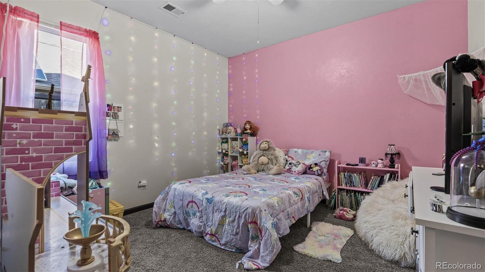556-32 32 5/8 Road Clifton, CO 81520 - Photo 21 of 28 a bedroom with a bed and a chandelier