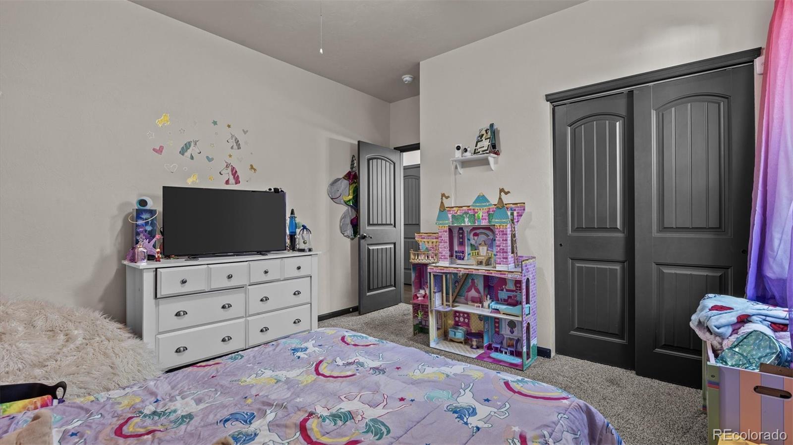 556-32 32 5/8 Road Clifton, CO 81520 - Photo 22 of 28 a bedroom with a bed and a television in it