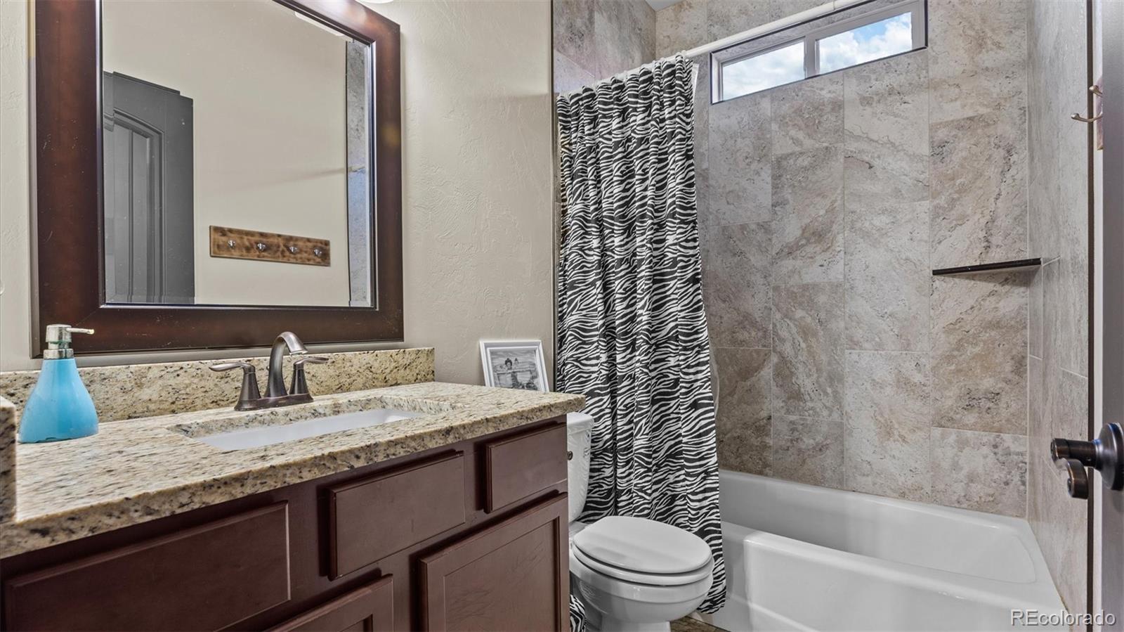 556-32 32 5/8 Road Clifton, CO 81520 - Photo 25 of 28 a bathroom with a granite countertop sink toilet and shower