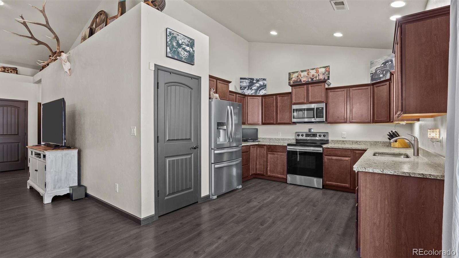 556-32 32 5/8 Road Clifton, CO 81520 - Photo 10 of 28 a kitchen with granite countertop stainless steel appliances and wooden cabinets