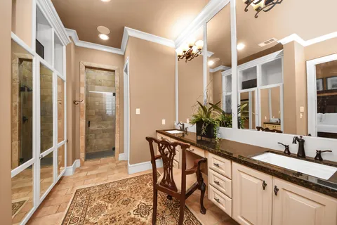 a bathroom with a granite countertop sink a mirror and a shower