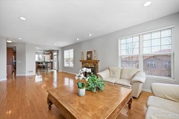 a living room with furniture dining table and wooden floor