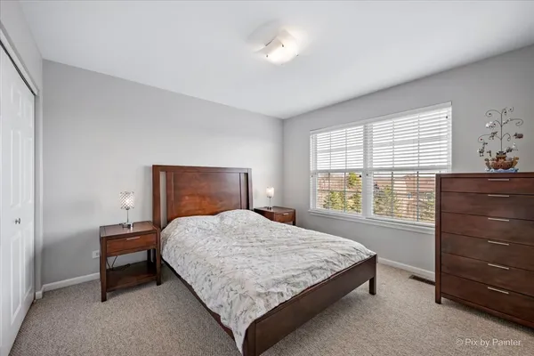 a bedroom with a bed and with furniture