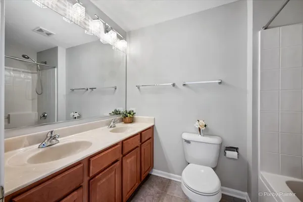 a bathroom with a toilet sink a mirror and vanity