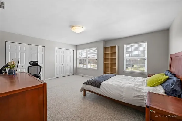 a bedroom with a bed and a desk