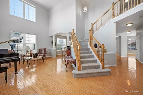 a view of entryway and hall with wooden floor