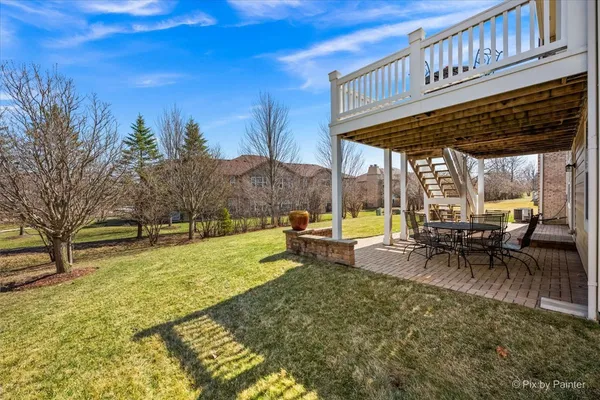 a view of a house with a yard and sitting area