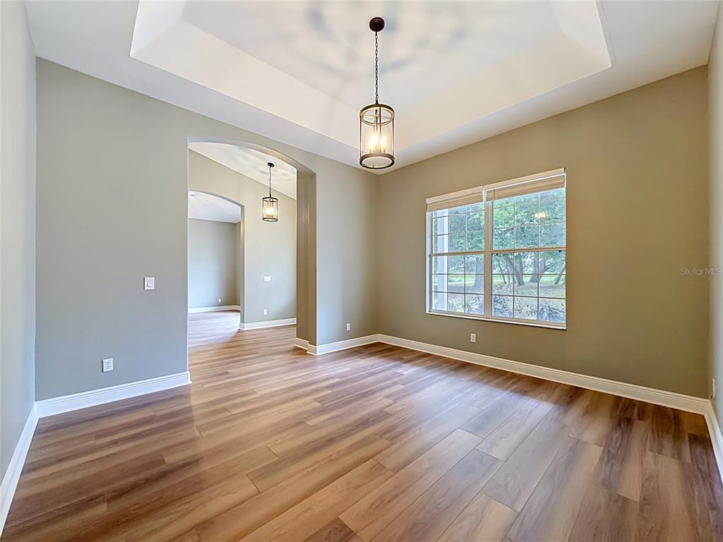 28549 Shirley Shores Road Tavares, FL 32778 - Photo 14 of 65 a view of an empty room with wooden floor and a window