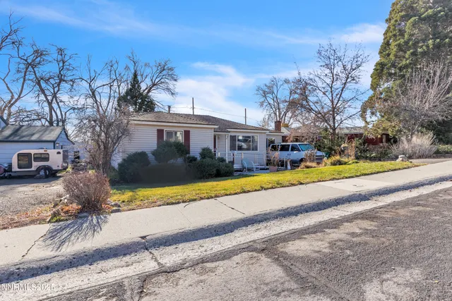 a view of house with yard and ocean view
