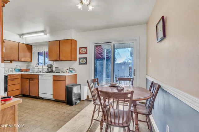 a view of kitchen with cabinets and window