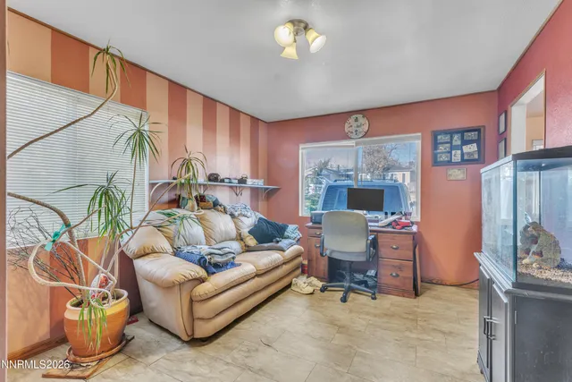 a living room with furniture a fireplace and a chandelier