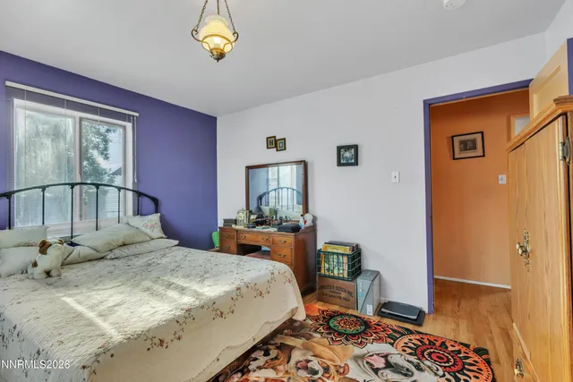 a bedroom with a bed dresser and a window