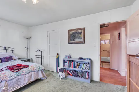 a bedroom with a bed and a book shelf