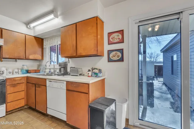 a kitchen with a sink cabinets and window