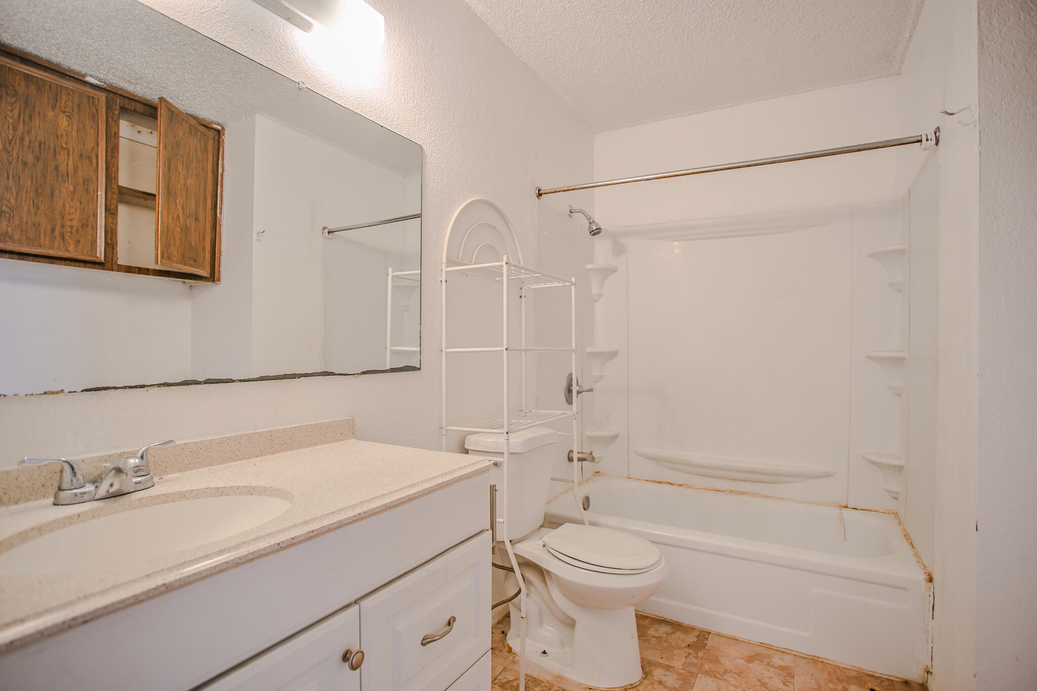 2620 Amherst Street Lubbock, TX 79415 - Photo 12 of 22 a bathroom with a granite countertop sink toilet and shower
