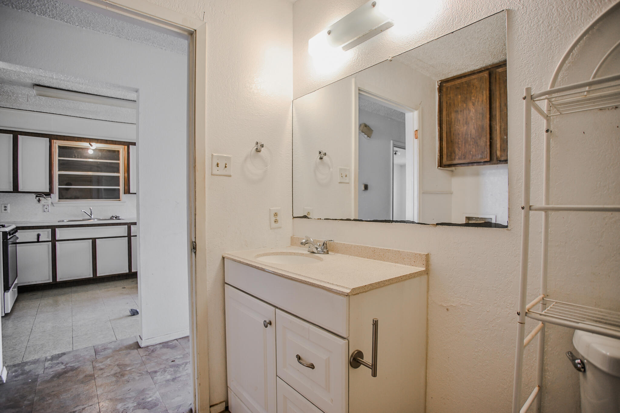 2620 Amherst Street Lubbock, TX 79415 - Photo 13 of 22 a bathroom with a sink and a mirror