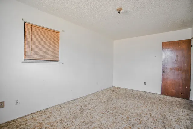 a view of empty room with ceiling fan