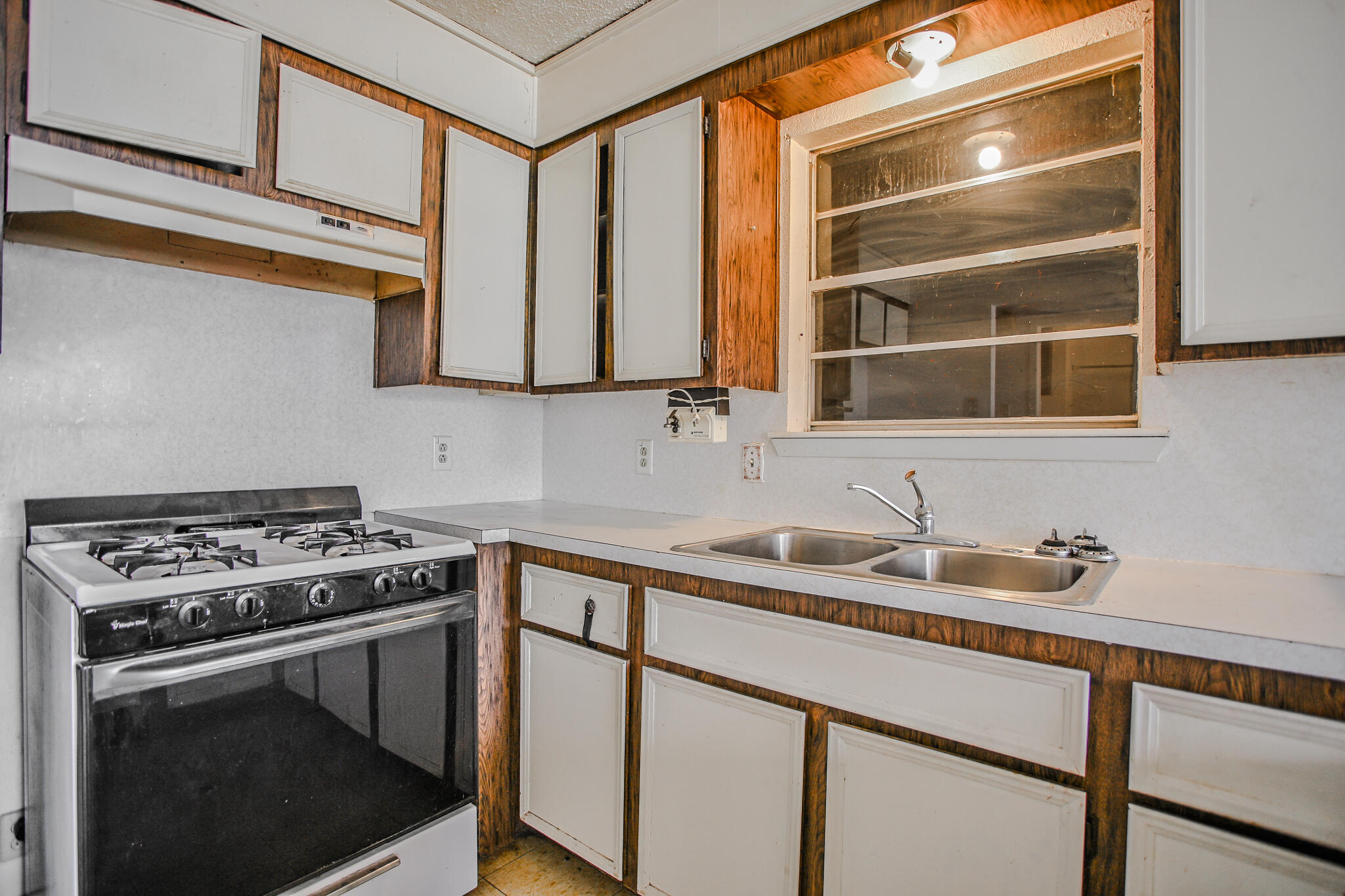 2620 Amherst Street Lubbock, TX 79415 - Photo 2 of 22 a kitchen with a sink stove top oven and cabinets