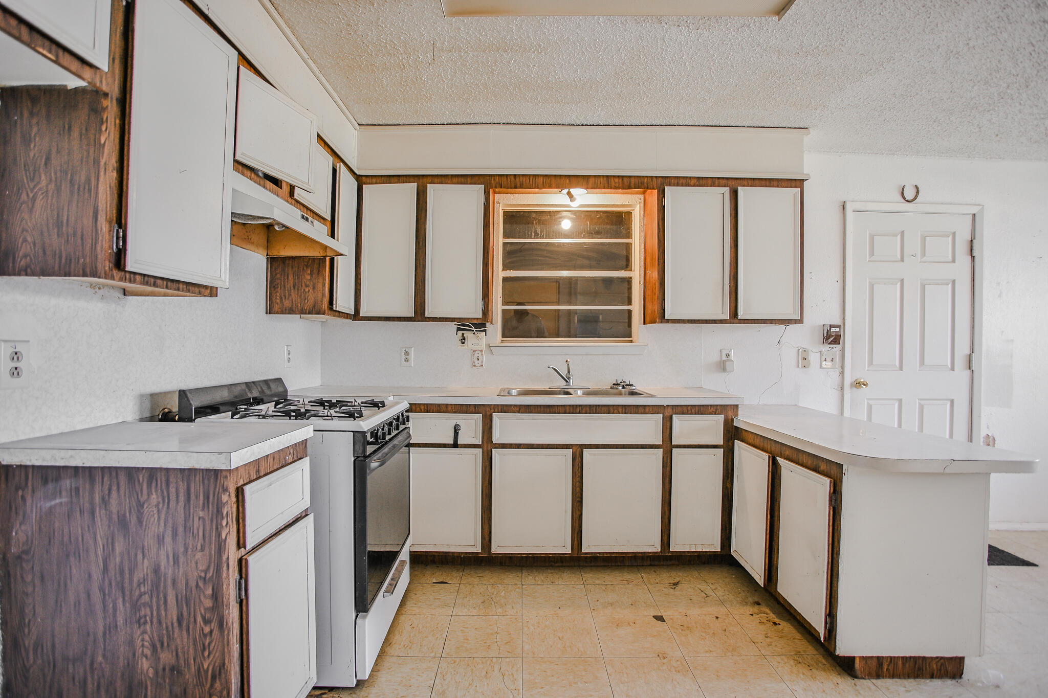 2620 Amherst Street Lubbock, TX 79415 - Photo 3 of 22 a kitchen with stainless steel appliances granite countertop a sink stove and cabinets