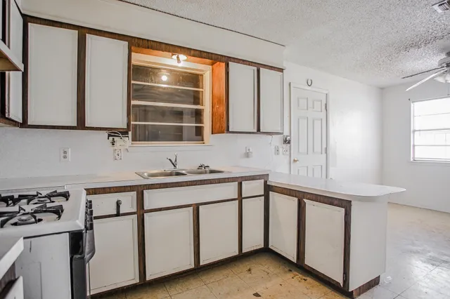 a kitchen that has a sink and a stove