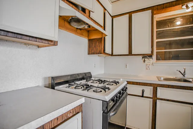 a kitchen with stainless steel appliances granite countertop a stove and a refrigerator