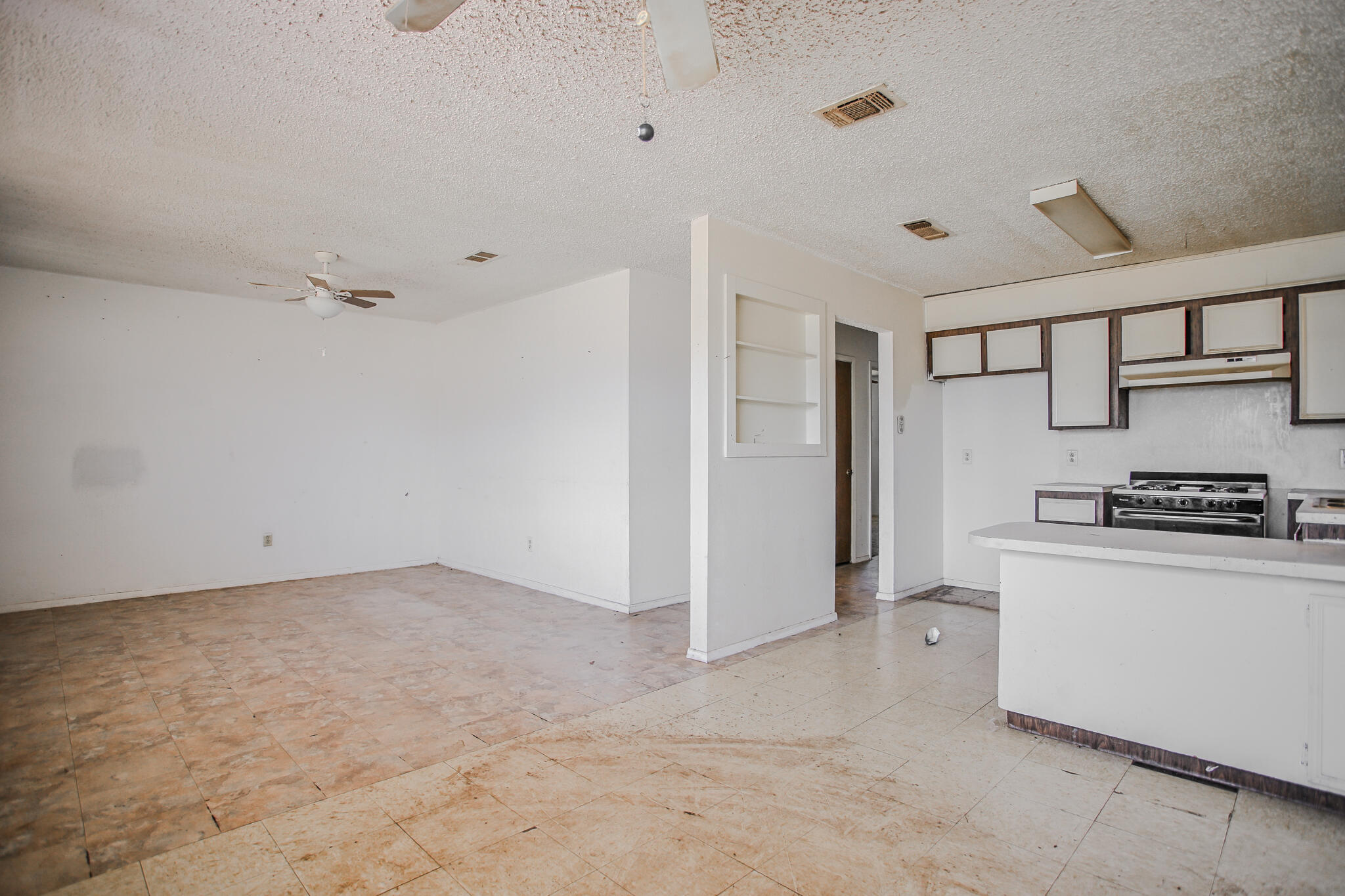 2620 Amherst Street Lubbock, TX 79415 - Photo 8 of 22 a kitchen with stainless steel appliances a refrigerator and a stove top oven