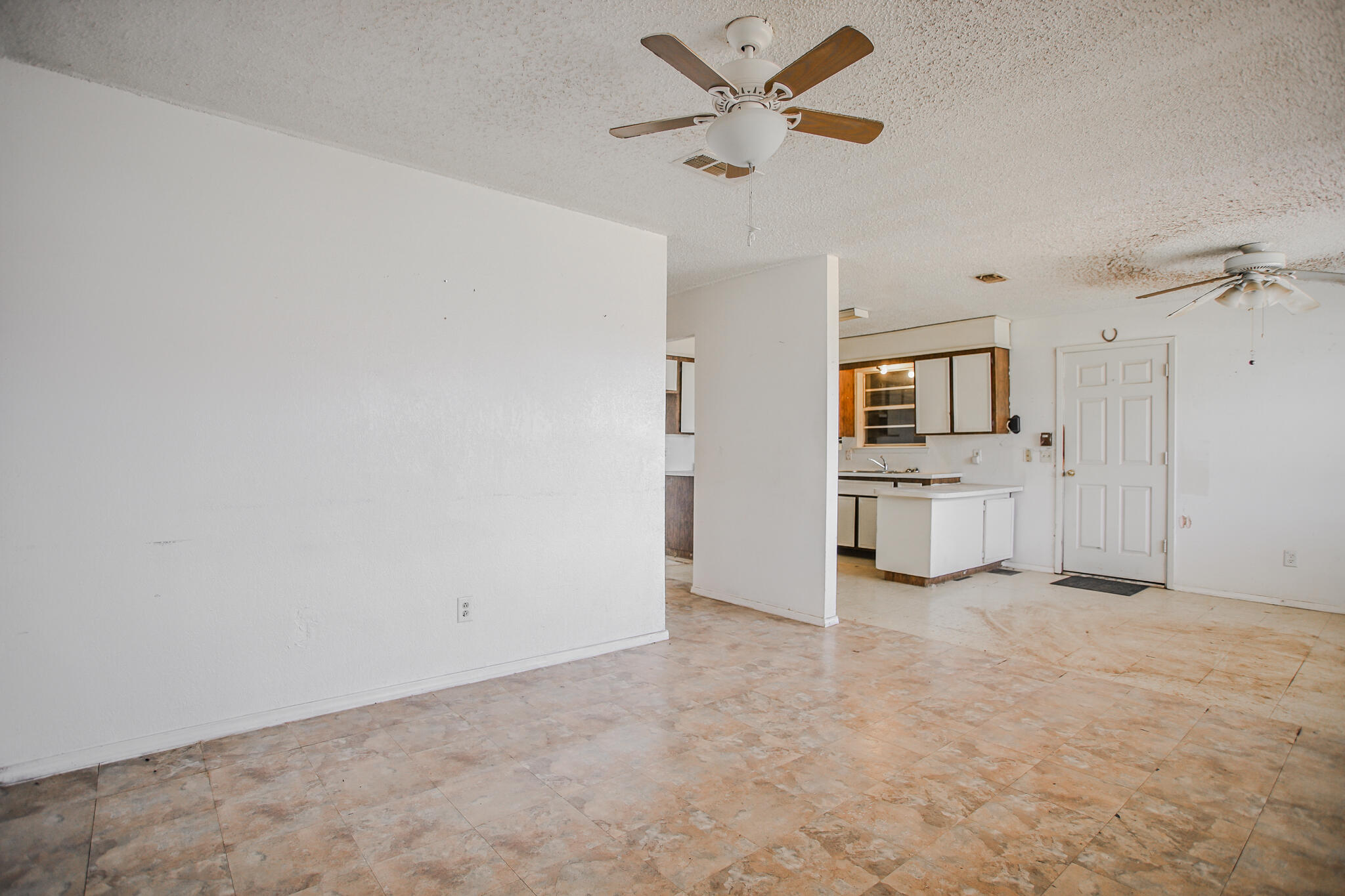 2620 Amherst Street Lubbock, TX 79415 - Photo 10 of 22 an empty room with a kitchen