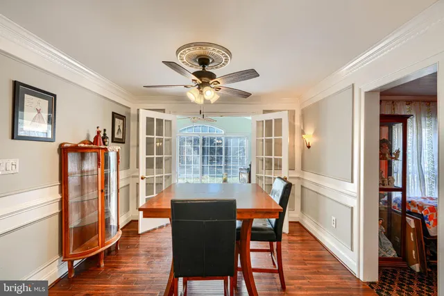 a view of a a dining room with furniture window and wooden floor