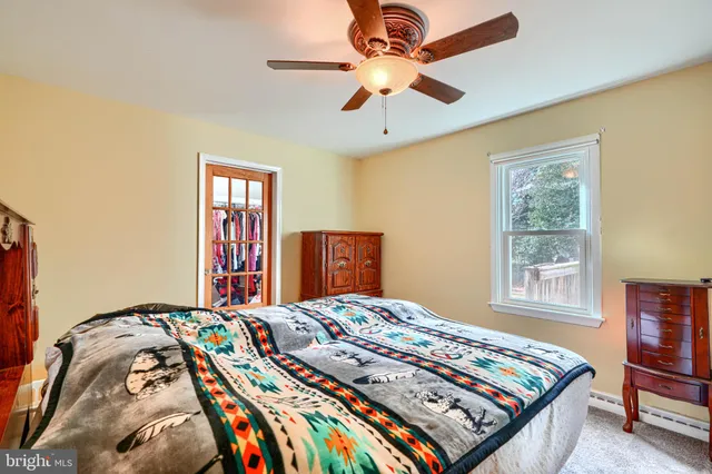 a bedroom with a bed dresser and a window