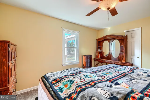 a bedroom with bed and a window