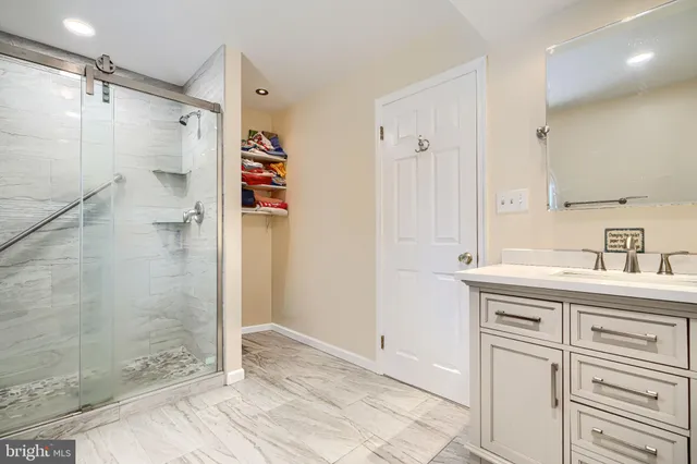 a bathroom with a shower sink and mirror