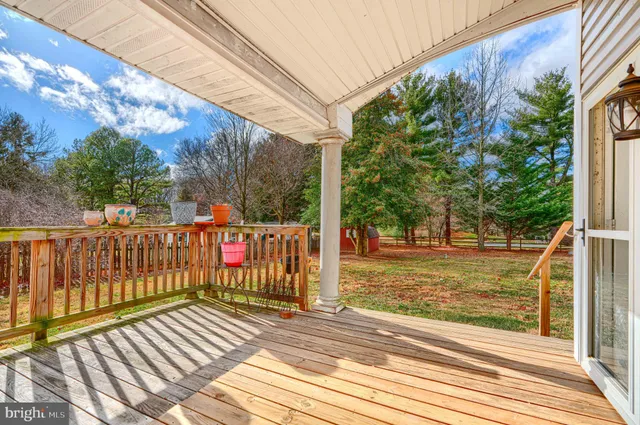 a view of a balcony with wooden floor and fence