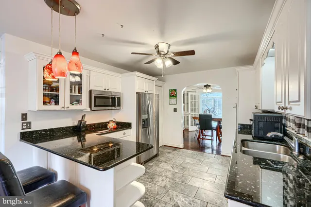a kitchen with stainless steel appliances a stove a sink and a refrigerator