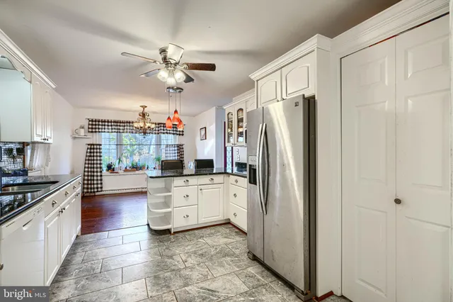 a kitchen with a refrigerator a sink and cabinets