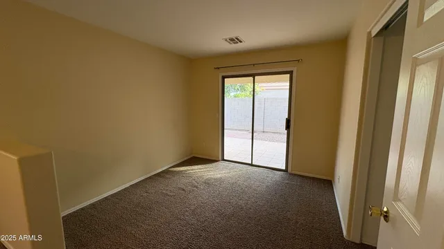 a view of an empty room and a window