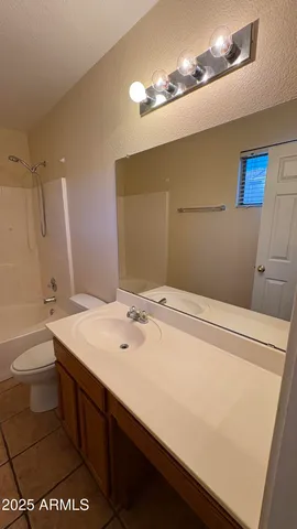 a bathroom with a sink a toilet and mirror