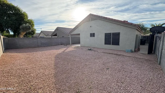 a view of a house with a backyard