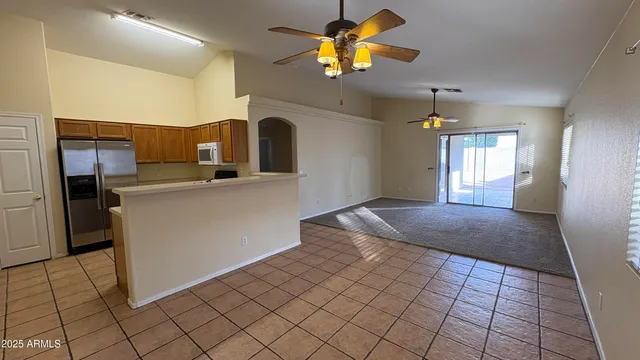 a kitchen with stainless steel appliances granite countertop a refrigerator a stove and a sink