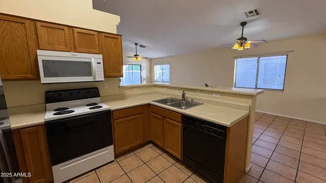 a kitchen with a sink stove and microwave