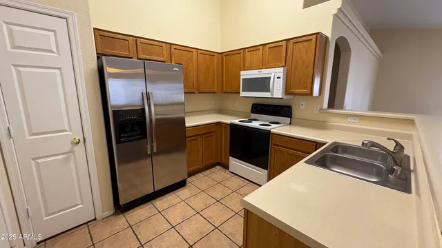 a kitchen with a sink appliances and cabinets