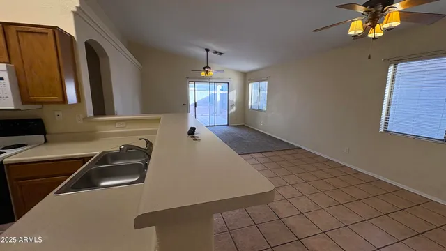 a kitchen with a sink cabinets and window