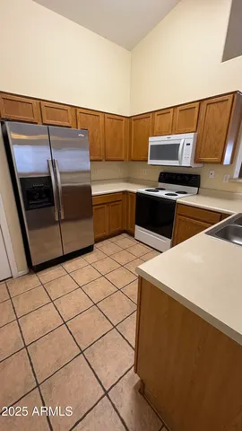 a kitchen with a sink and a refrigerator