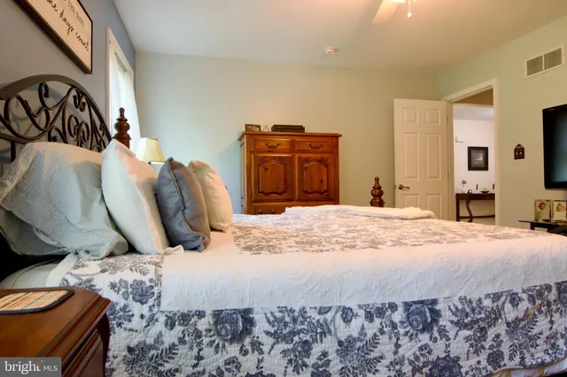 a bed sitting in a bedroom next to a bedroom