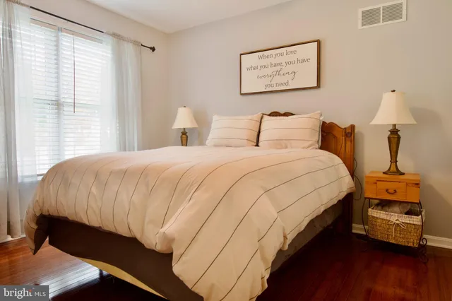 a bedroom with bed and wooden floor