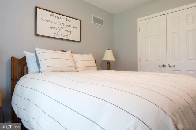 a bedroom with bed and cupboard