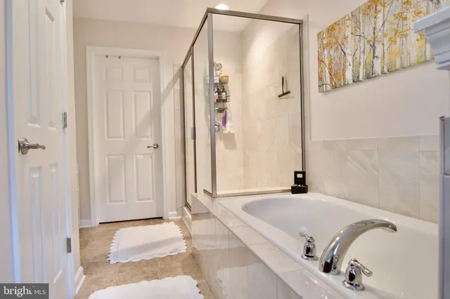 a bathroom with a tub and a shower