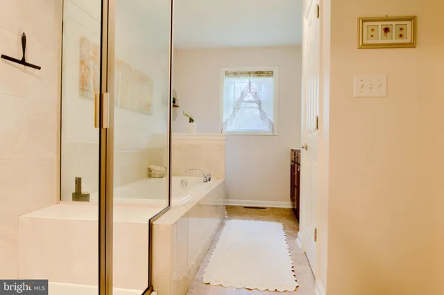 a bathroom with a tub and shower